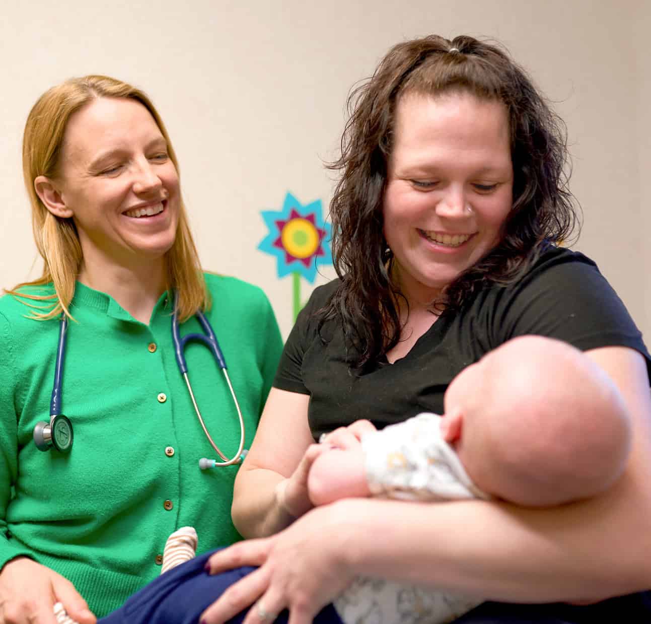 nurse with mom and baby